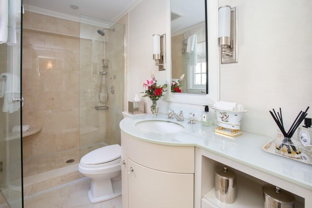 97 Laurel Road Brookline, MA 02467 - Photo 12 of 33 a bathroom with a sink toilet a mirror and shower
