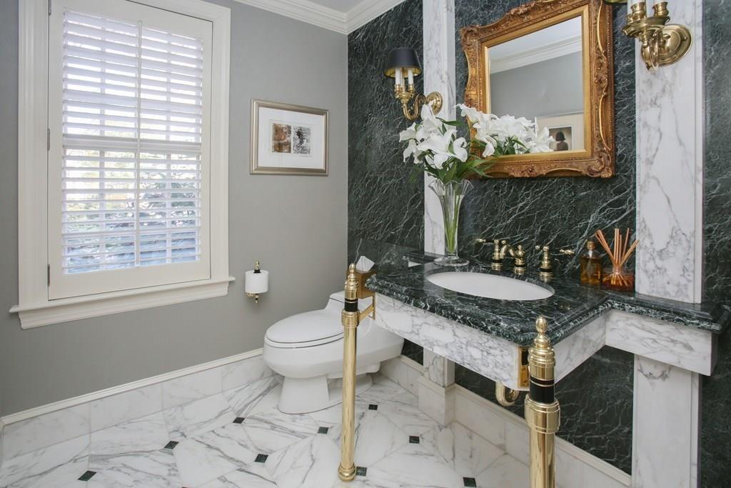 97 Laurel Road Brookline, MA 02467 - Photo 13 of 33 a bathroom with a granite countertop sink a toilet a mirror and shower