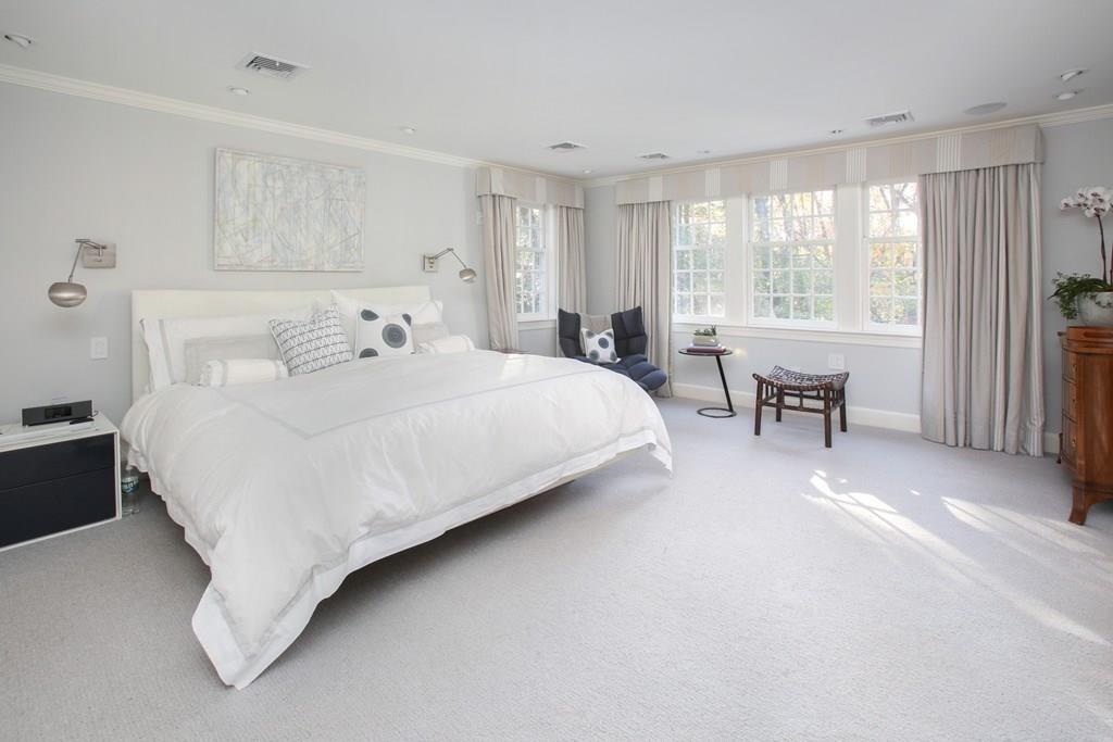 97 Laurel Road Brookline, MA 02467 - Photo 15 of 33 a bedroom with a bed couch and windows