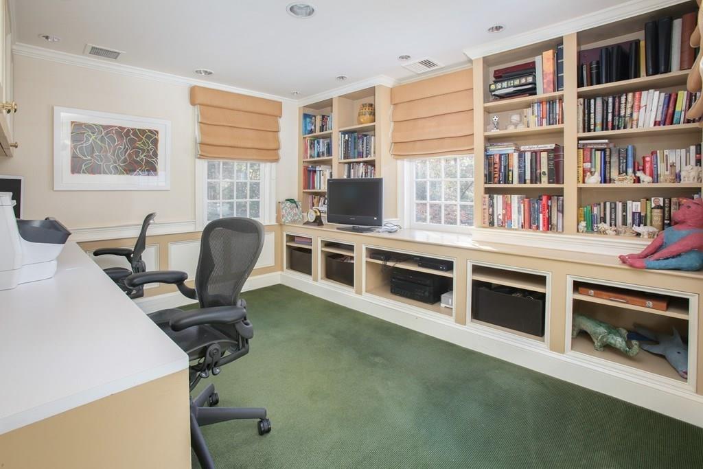 97 Laurel Road Brookline, MA 02467 - Photo 19 of 33 a view of a workspace with furniture and a bookshelf