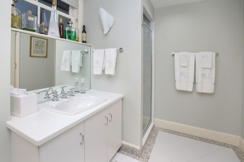 97 Laurel Road Brookline, MA 02467 - Photo 23 of 33 a bathroom with a sink and a mirror