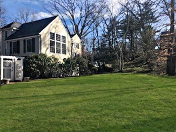 97 Laurel Road Brookline, MA 02467 - Photo 29 of 33 a view of a white house with a yard and large trees