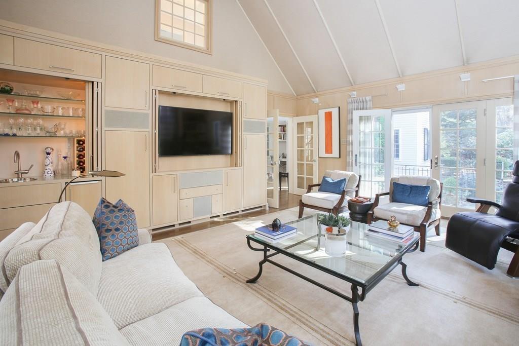 97 Laurel Road Brookline, MA 02467 - Photo 9 of 33 a living room with furniture a flat screen tv and a large window