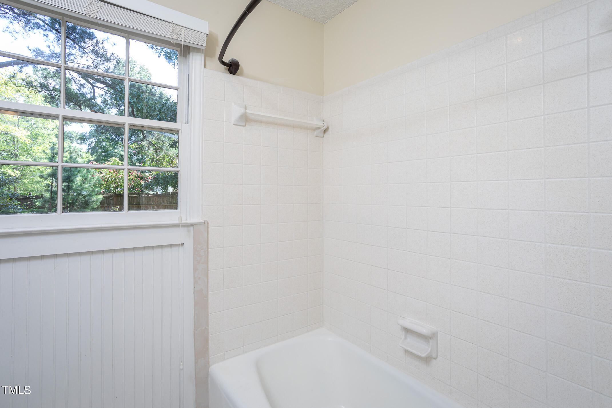 1717 Bayleaf Trail Raleigh, NC 27614 - Photo 22 of 35 a bathroom with a white bath tub and a window