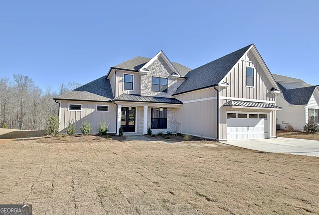 a view of a brick house with many windows next to a yard
