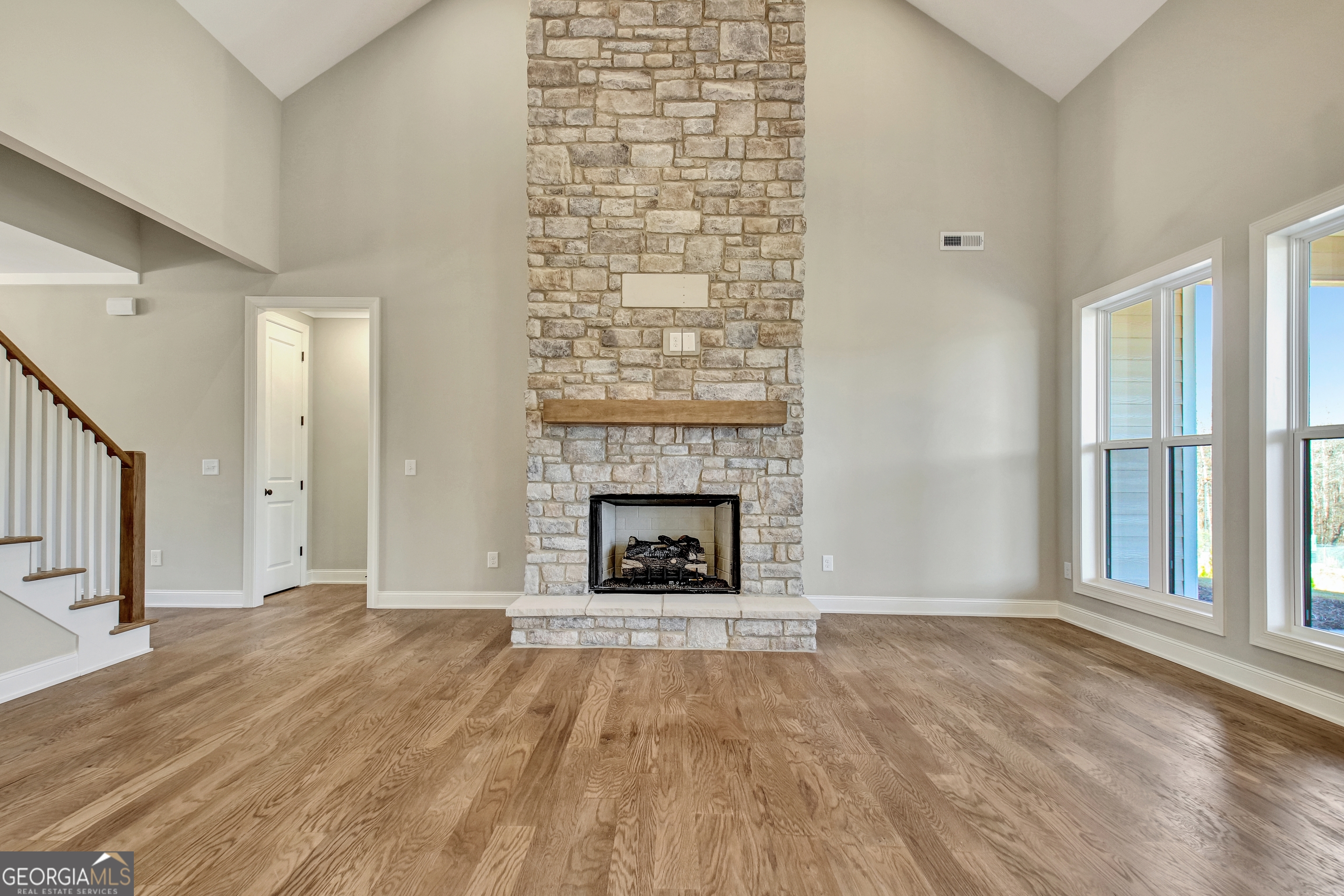 355 Werner Way Senoia, GA 30276 - Photo 20 of 118 wooden floor fireplace and windows in an empty room