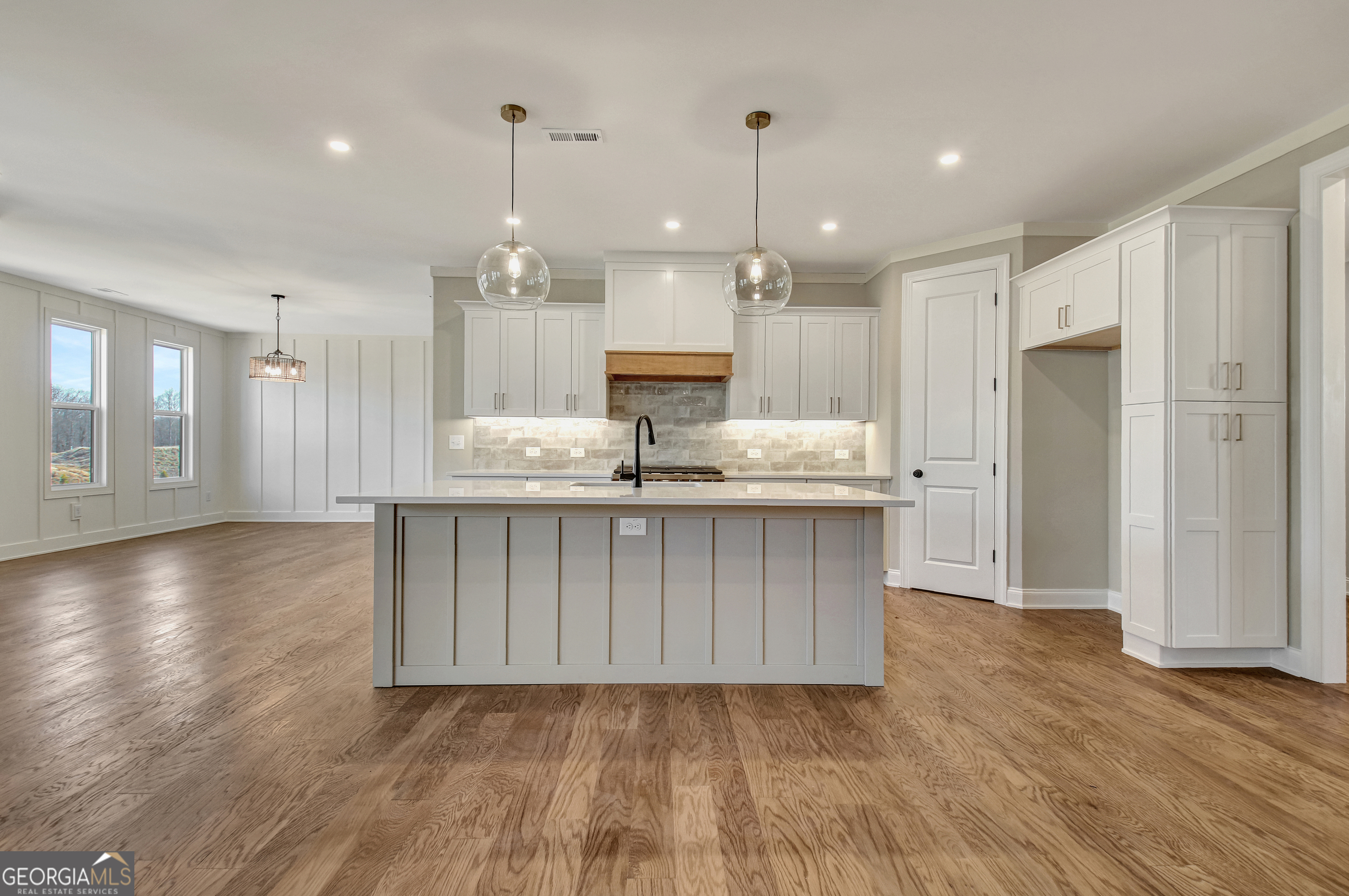 355 Werner Way Senoia, GA 30276 - Photo 23 of 118 a large kitchen with granite countertop a large counter top a sink stainless steel appliances and cabinets