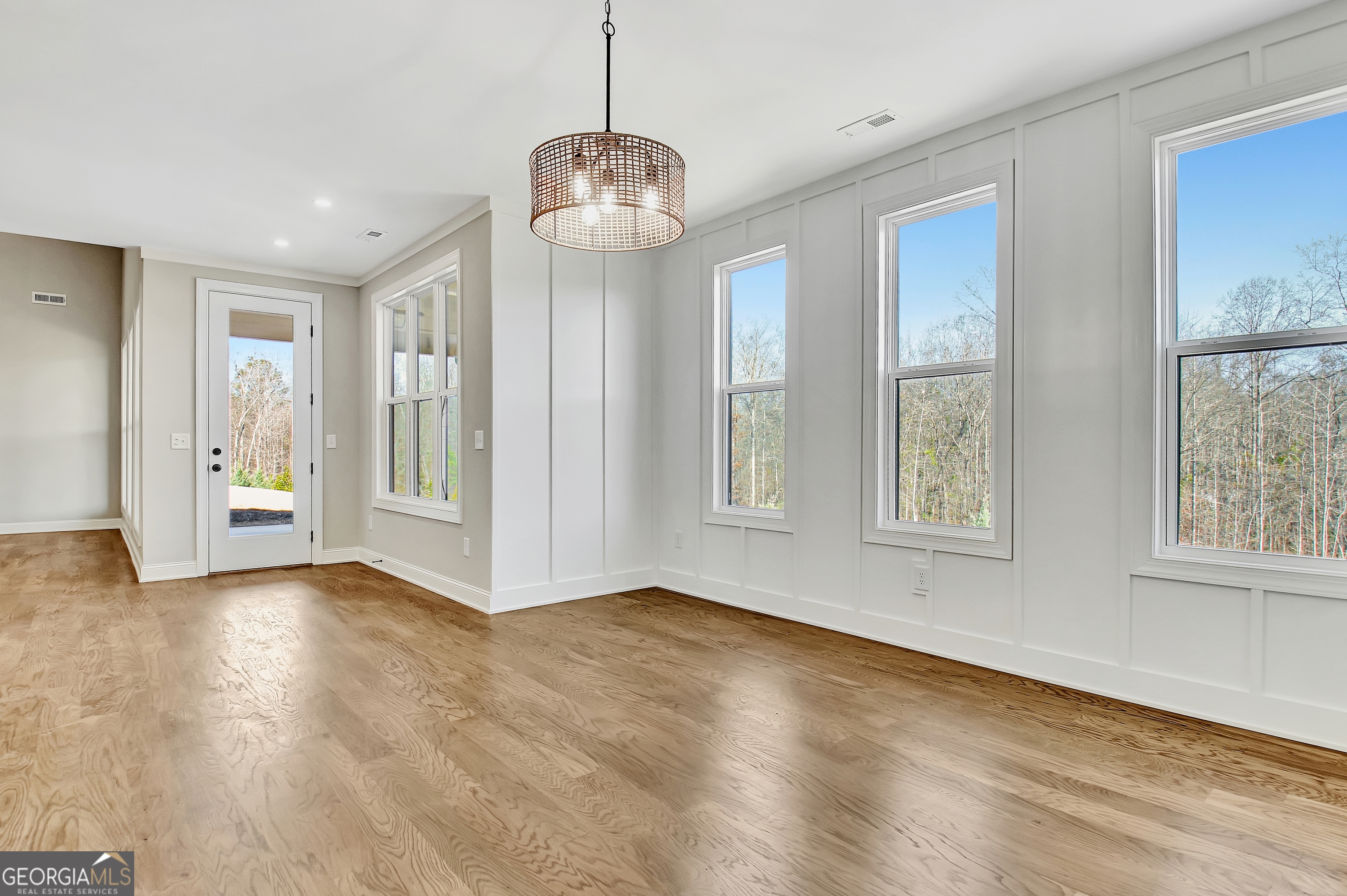 355 Werner Way Senoia, GA 30276 - Photo 38 of 118 a view of an empty room with wooden floor and a window
