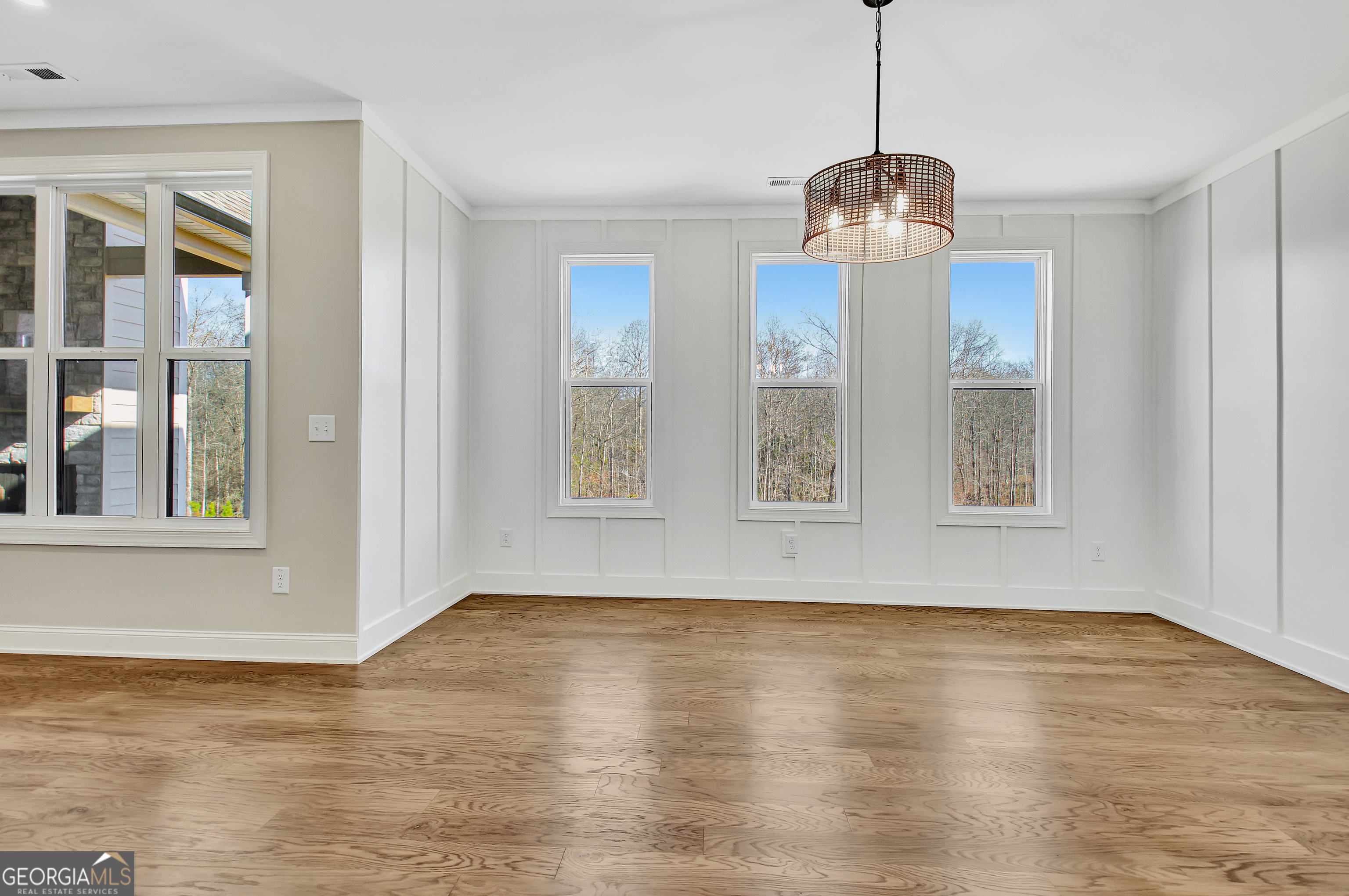 355 Werner Way Senoia, GA 30276 - Photo 40 of 118 a view of an empty room with wooden floor and a window