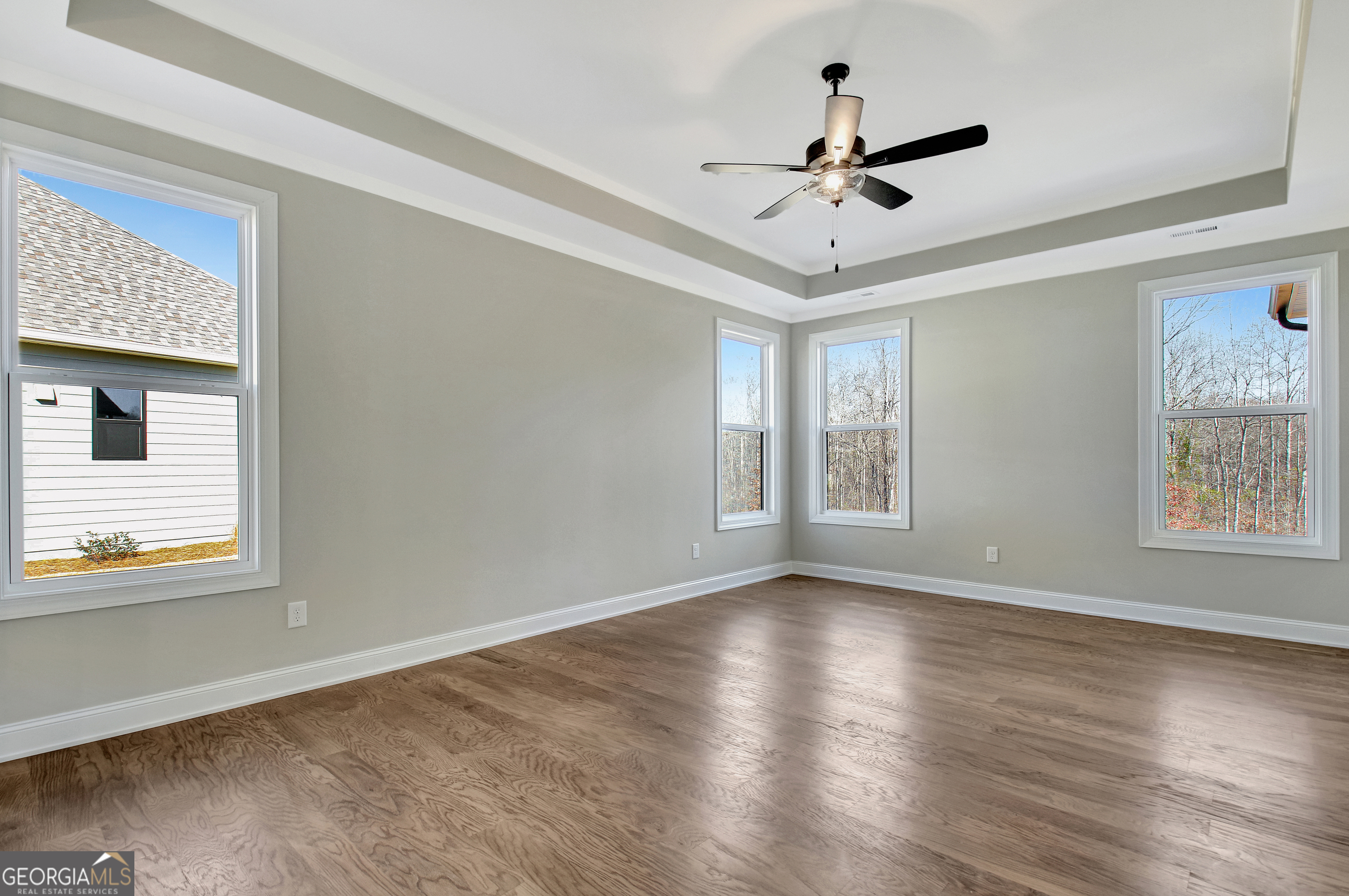 355 Werner Way Senoia, GA 30276 - Photo 47 of 118 a view of empty room with wooden floor and ceiling fan