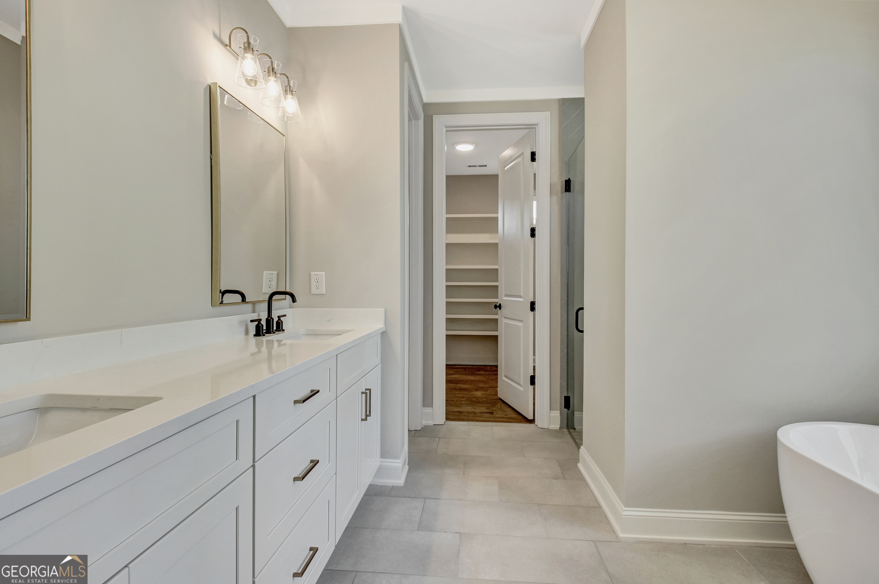 355 Werner Way Senoia, GA 30276 - Photo 50 of 118 a spacious bathroom with a double vanity sink a mirror and a bathtub