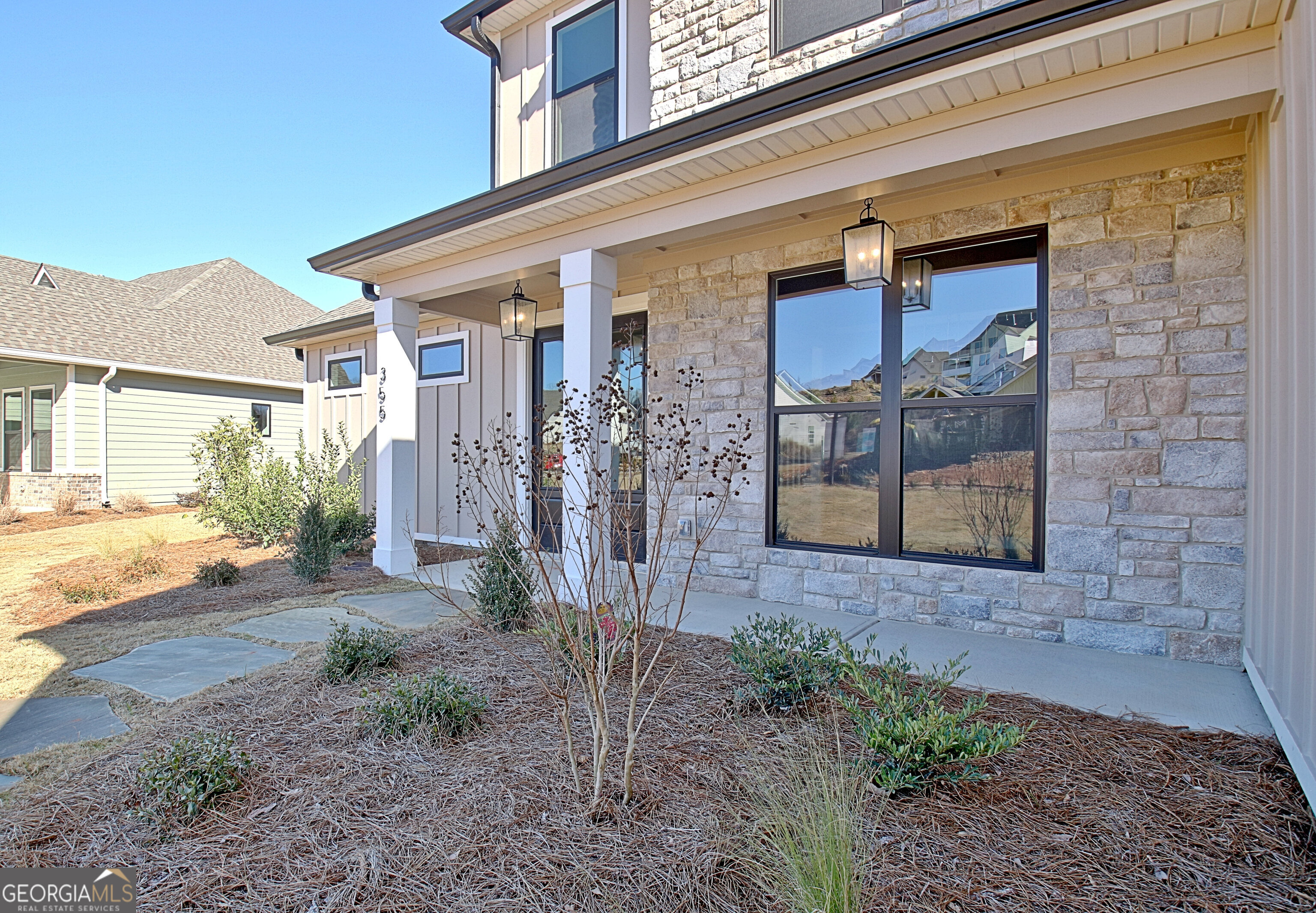 355 Werner Way Senoia, GA 30276 - Photo 5 of 118 a view of a brick house with many windows next to a yard