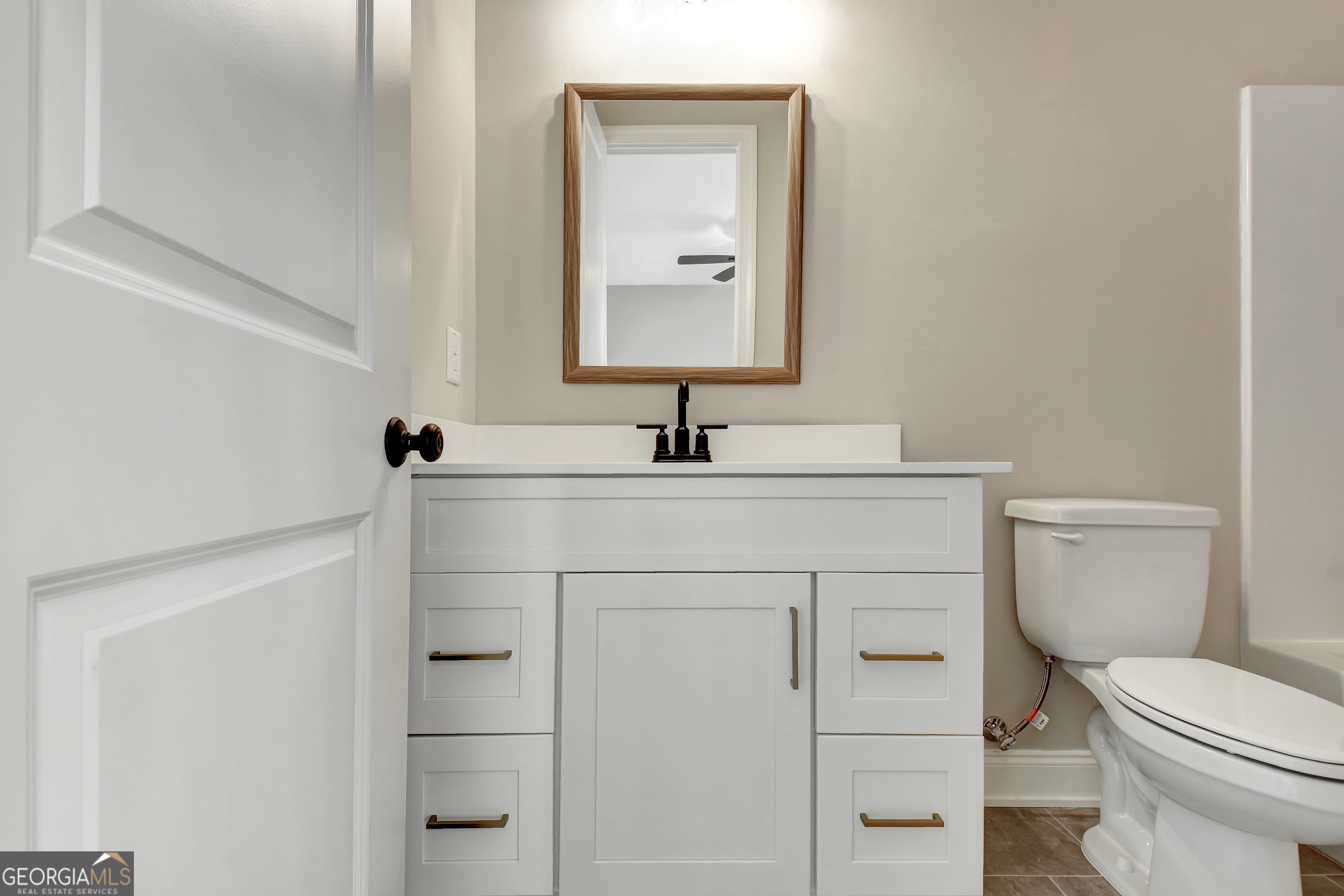 355 Werner Way Senoia, GA 30276 - Photo 81 of 118 a bathroom with a toilet sink and mirror