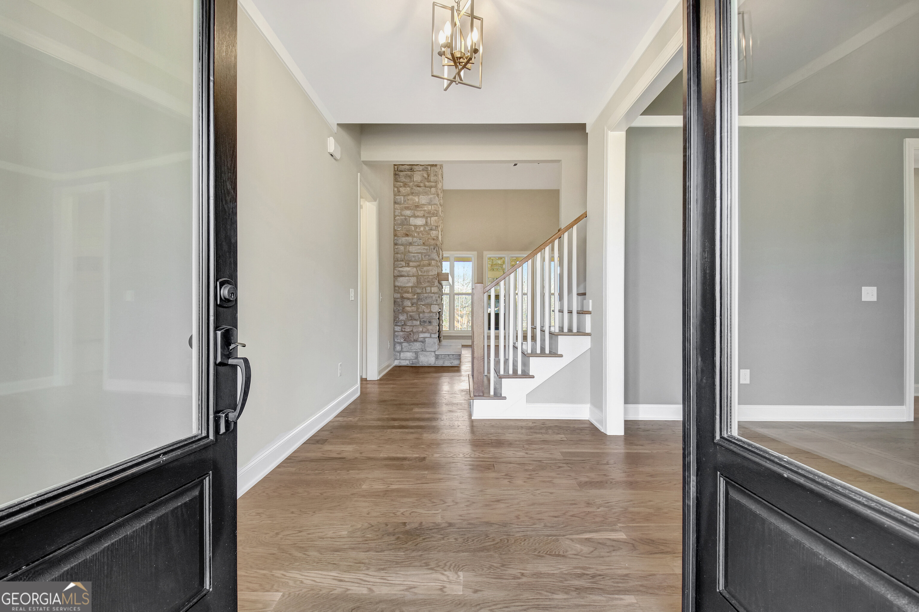355 Werner Way Senoia, GA 30276 - Photo 9 of 118 a view of a hallway with wooden floor and staircase