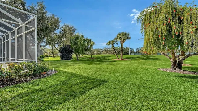 a living room with furniture a chandelier and a dining table