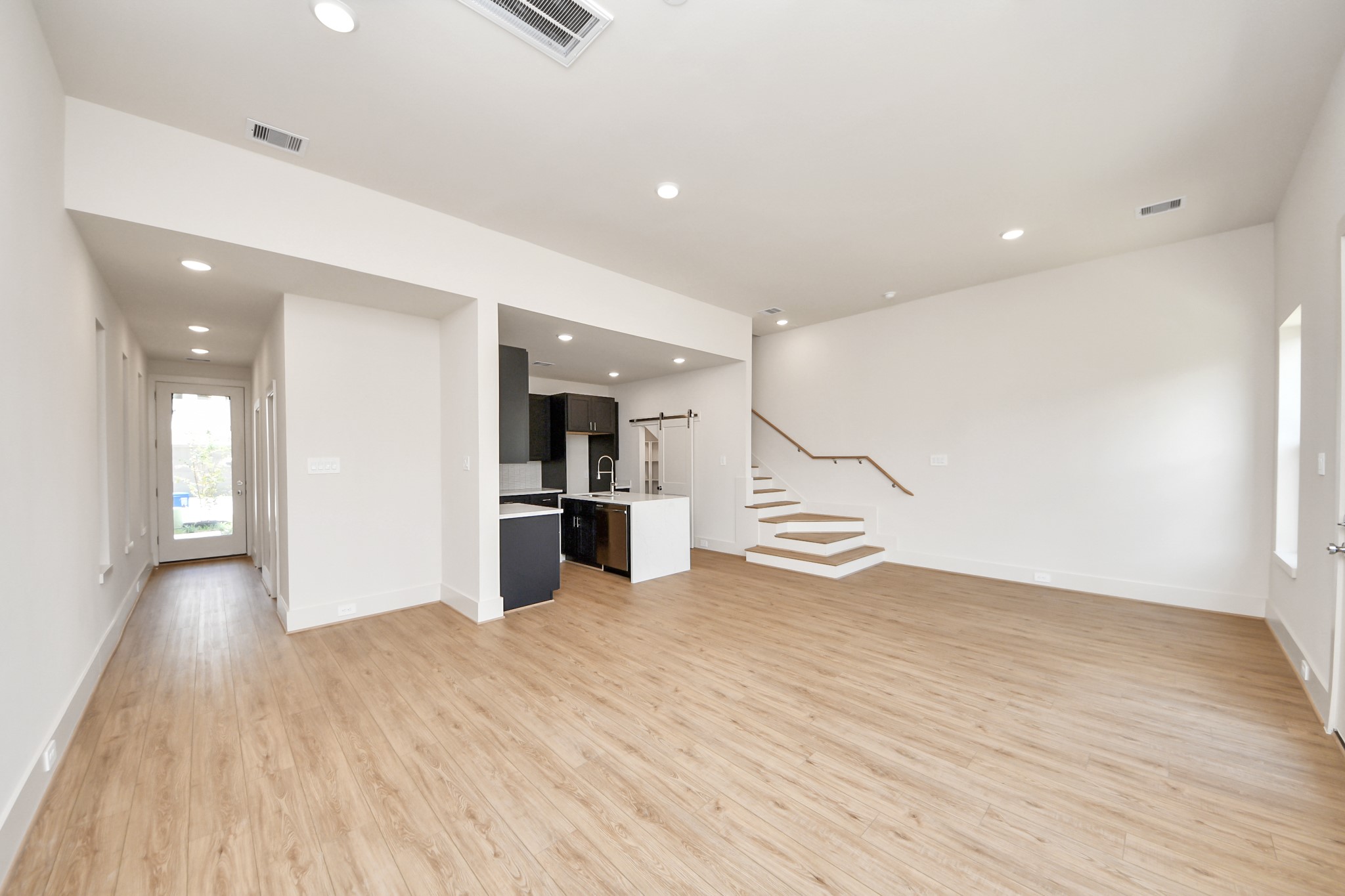 5903 Urban Pines Street Houston, TX 77091 - Photo 24 of 42 a view of a big room with wooden floor and windows
