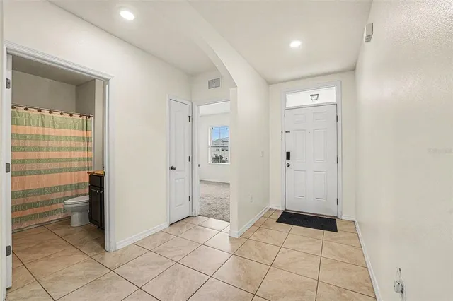 an empty room with cabinet and mirrors