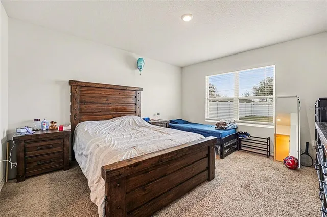 a bed room with a bed and a window