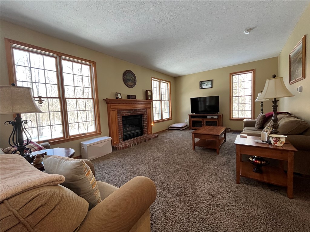 12837 Upton Road Victory, NY 13143 - Photo 11 of 48 Living room with fireplace insert (2023). Outstand