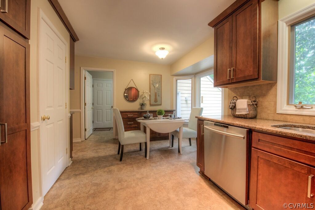 14208 Spring Gate Road Midlothian, VA 23112 - Photo 11 of 44 a kitchen with cabinets a sink dishwasher a dining table and chairs with wooden floor