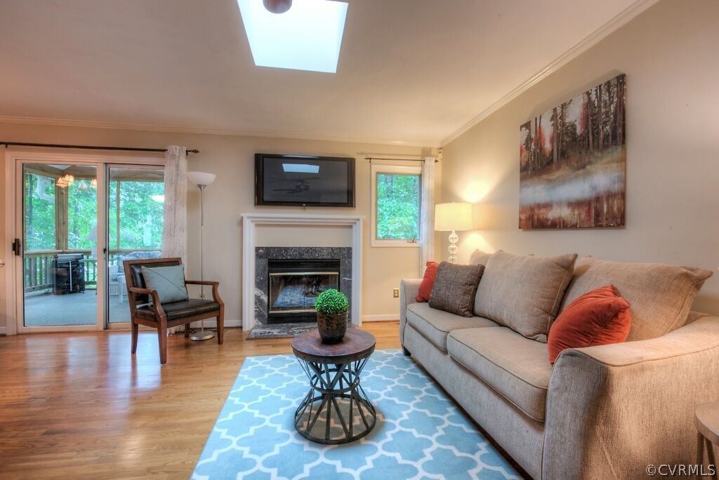 14208 Spring Gate Road Midlothian, VA 23112 - Photo 20 of 44 a living room with furniture a flat screen tv and a fireplace