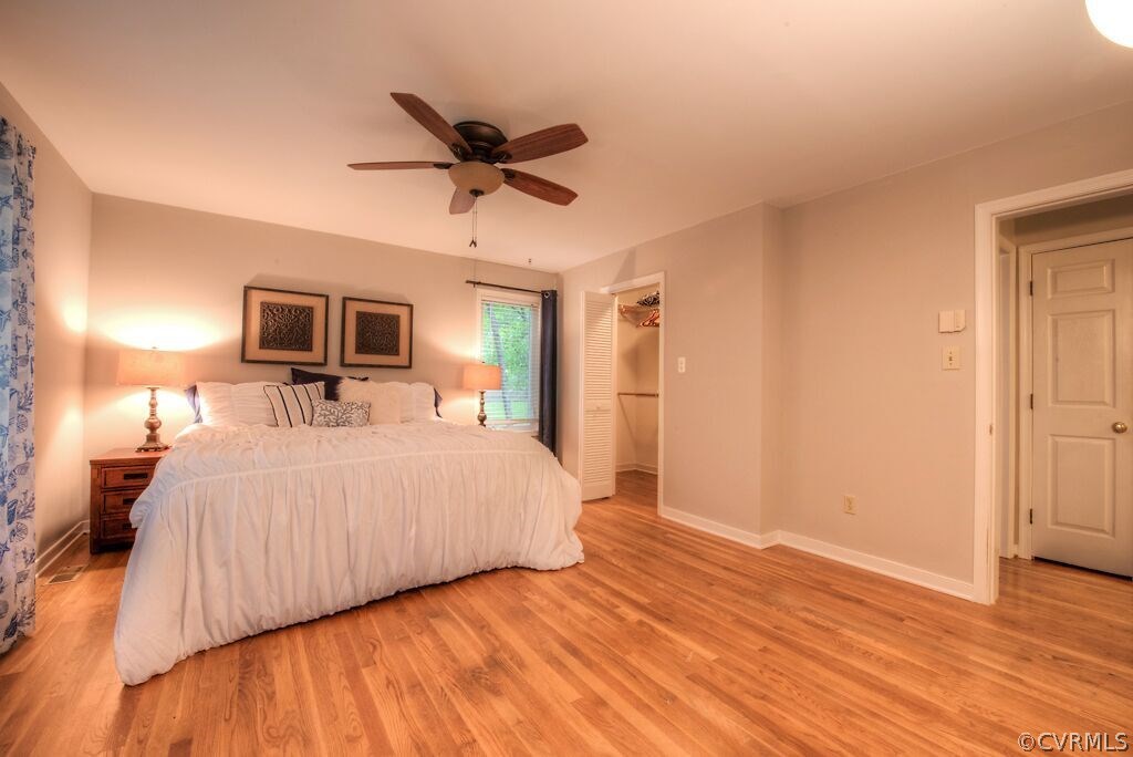 14208 Spring Gate Road Midlothian, VA 23112 - Photo 21 of 44 a bed room with a bed a window and a chandelier