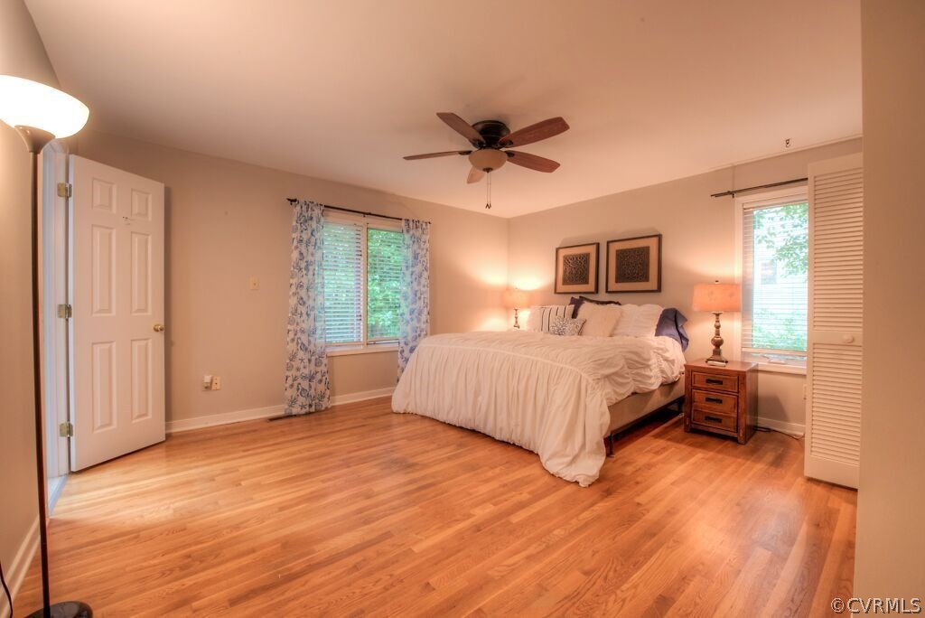 14208 Spring Gate Road Midlothian, VA 23112 - Photo 22 of 44 a bedroom with a large bed and wooden floor