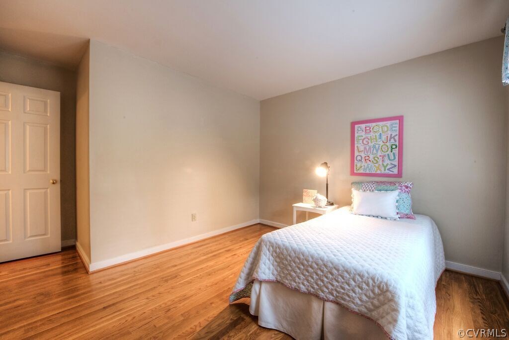 14208 Spring Gate Road Midlothian, VA 23112 - Photo 27 of 44 a bedroom with a bed and wooden floor