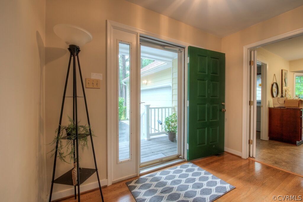 14208 Spring Gate Road Midlothian, VA 23112 - Photo 3 of 44 a view of a hallway with wooden floor and a living room
