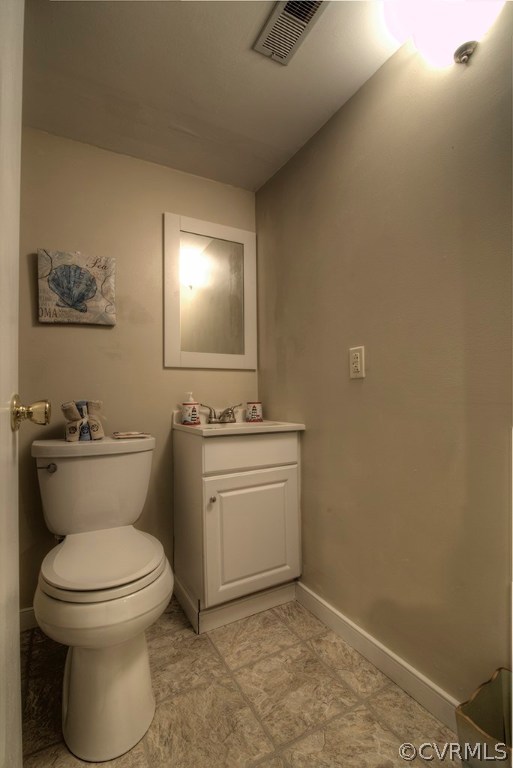 14208 Spring Gate Road Midlothian, VA 23112 - Photo 37 of 44 a bathroom with a toilet a sink and mirror