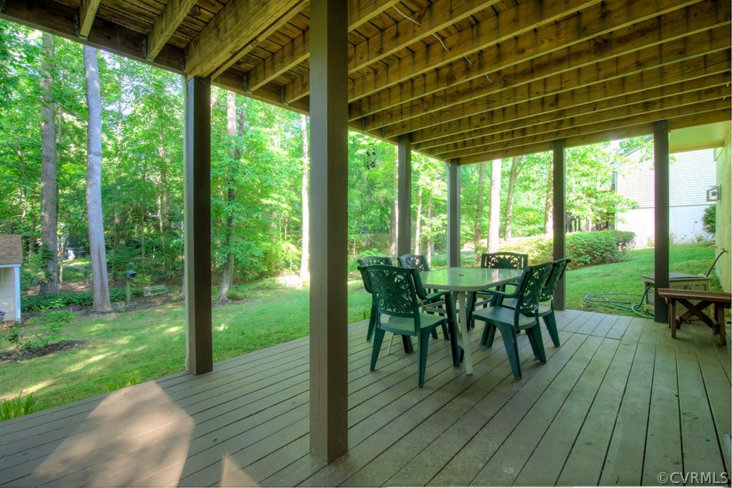14208 Spring Gate Road Midlothian, VA 23112 - Photo 39 of 44 a view of a patio with table and chairs and wooden floor