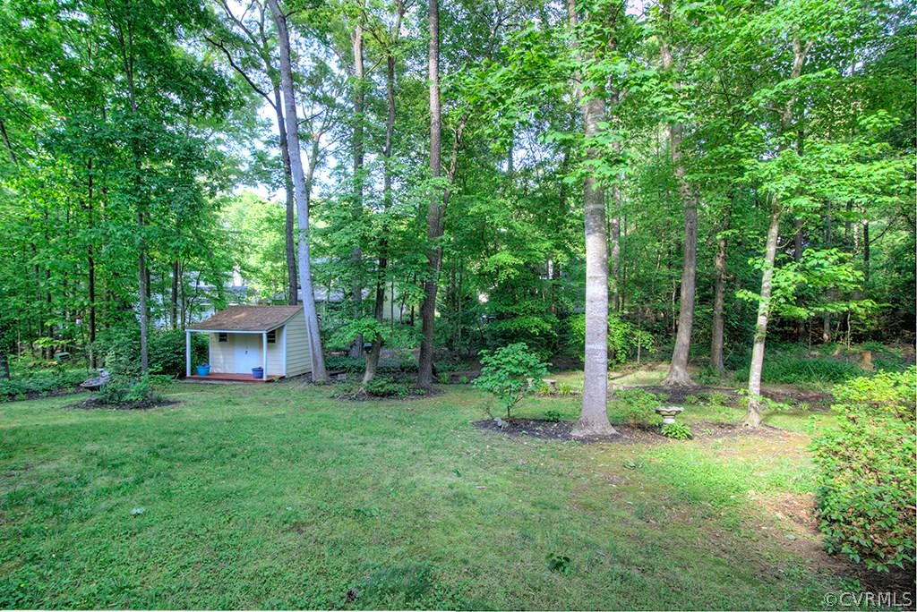 14208 Spring Gate Road Midlothian, VA 23112 - Photo 41 of 44 a view of a backyard with plants and large trees