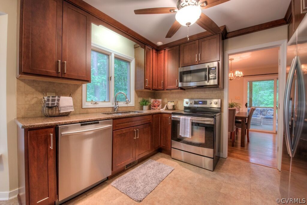 14208 Spring Gate Road Midlothian, VA 23112 - Photo 6 of 44 a kitchen with granite countertop a stove top oven microwave and cabinets