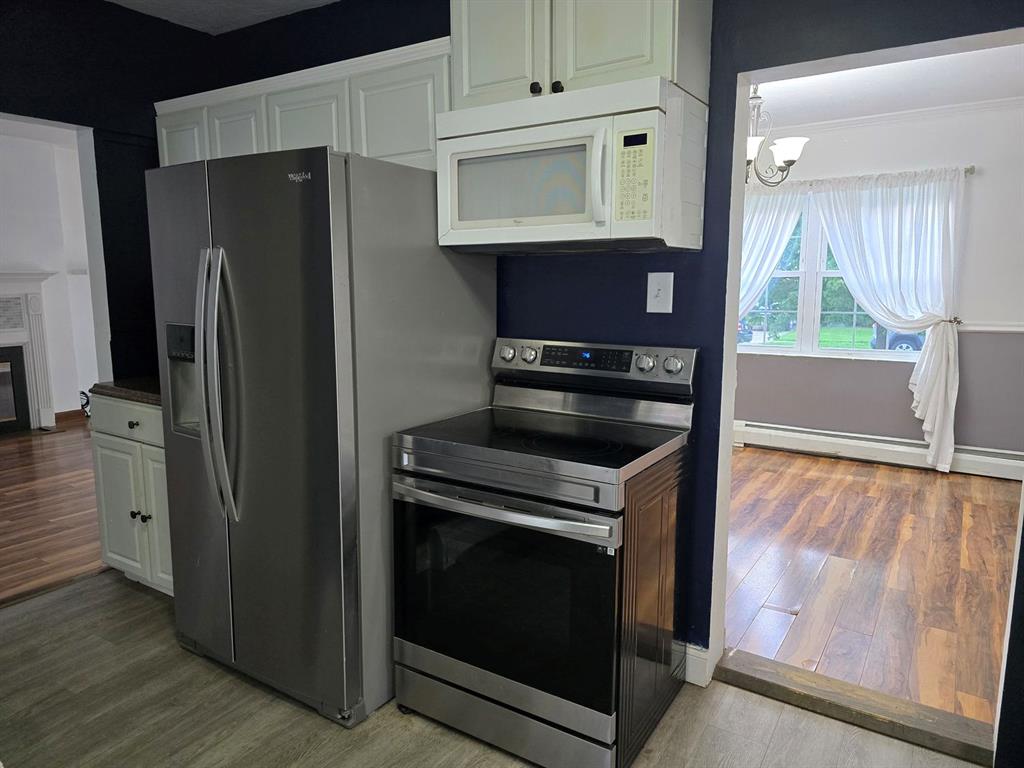 1008 Manor Road New Kensington, PA 15068 - Photo 23 of 39 a kitchen with stainless steel appliances granite countertop a stove a refrigerator and a microwave