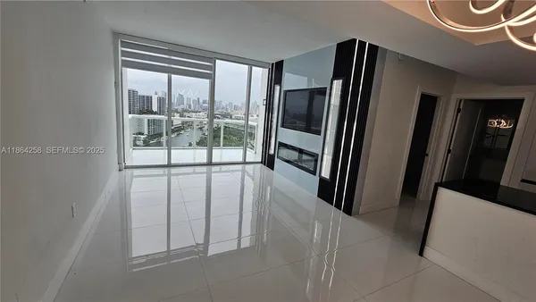 a view of a hallway with wooden floor and glass door