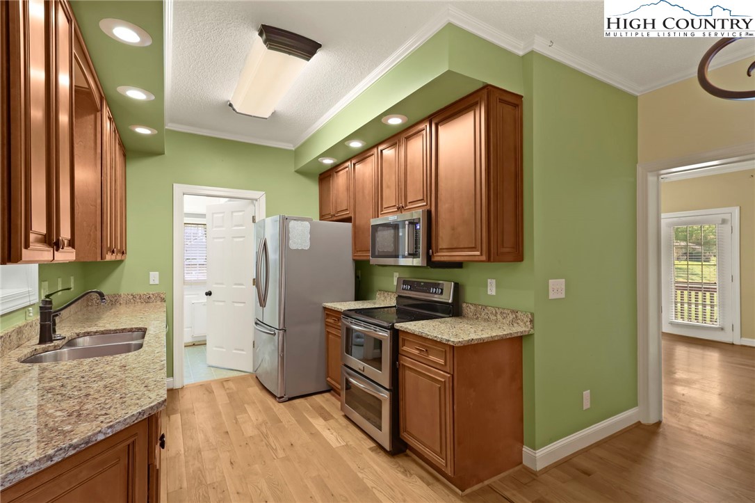 112 Rolling Hill Drive Boone, NC 28607 - Photo 12 of 31 a kitchen with stainless steel appliances granite countertop a sink stove and refrigerator