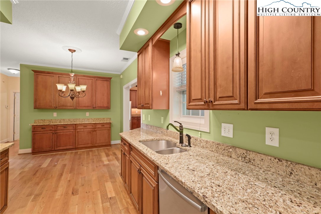 112 Rolling Hill Drive Boone, NC 28607 - Photo 13 of 31 a kitchen with stainless steel appliances granite countertop a sink a stove and cabinets