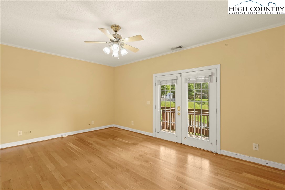 112 Rolling Hill Drive Boone, NC 28607 - Photo 17 of 31 a view of an empty room with wooden floor and a window