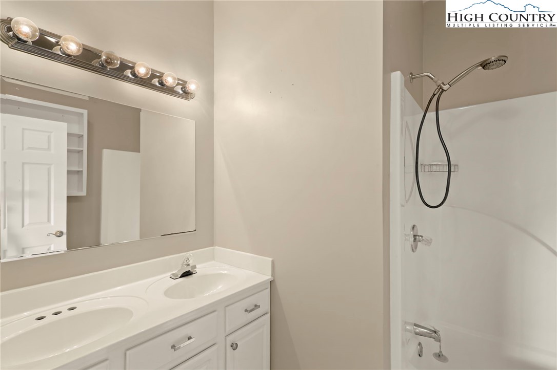 112 Rolling Hill Drive Boone, NC 28607 - Photo 19 of 31 a bathroom with a sink a vanity and mirror
