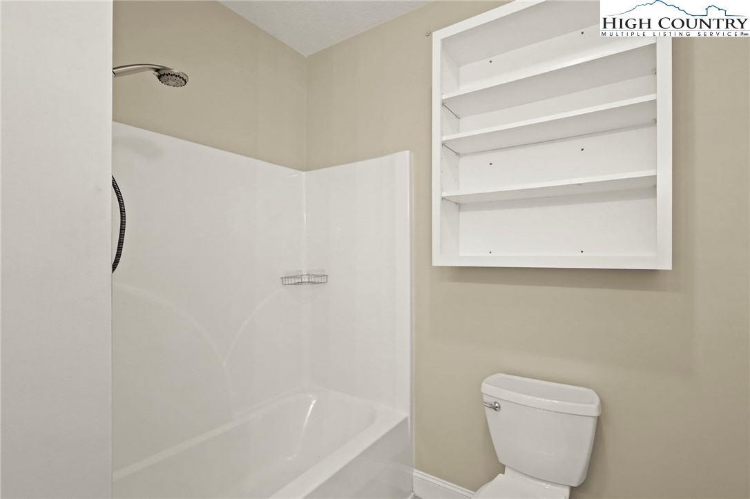 112 Rolling Hill Drive Boone, NC 28607 - Photo 20 of 31 a bathroom with a toilet and a bathtub
