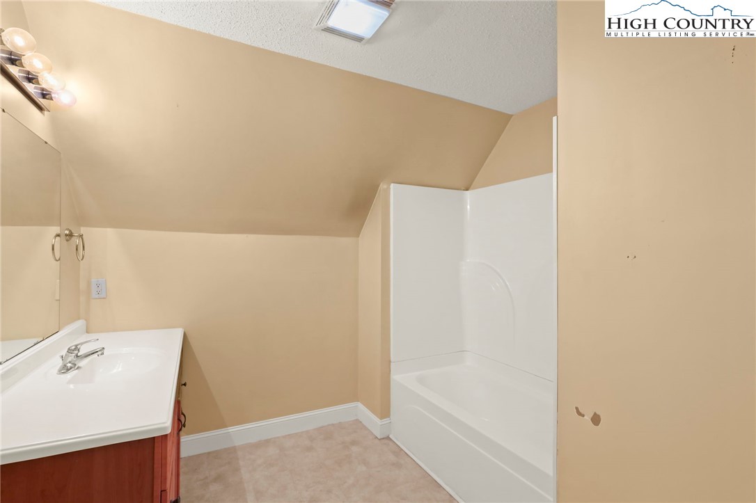 112 Rolling Hill Drive Boone, NC 28607 - Photo 26 of 31 a bathroom with a bathtub and a sink