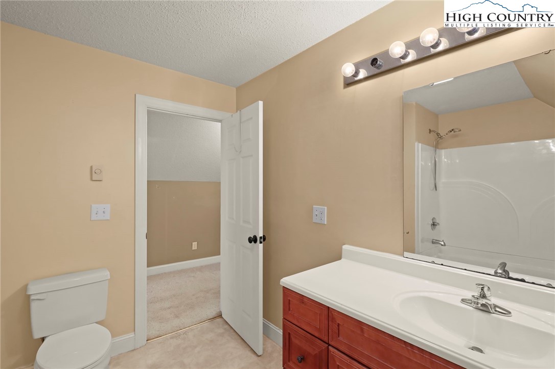 112 Rolling Hill Drive Boone, NC 28607 - Photo 27 of 31 a bathroom with a sink a toilet and shower