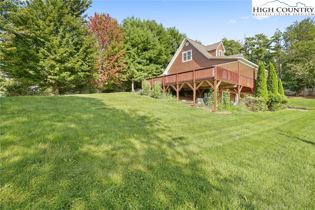 112 Rolling Hill Drive Boone, NC 28607 - Photo 3 of 31 a view of a big house with a big yard and large trees