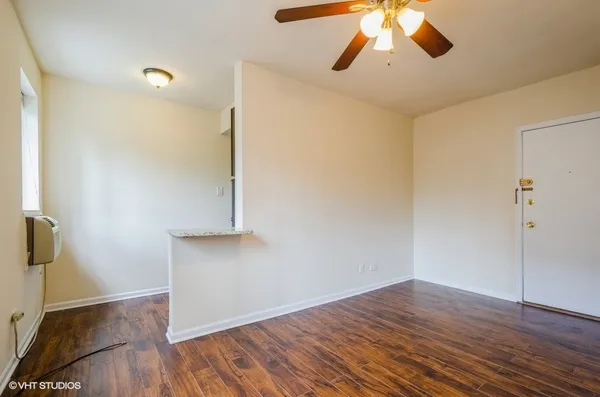 a view of empty room with wooden floor