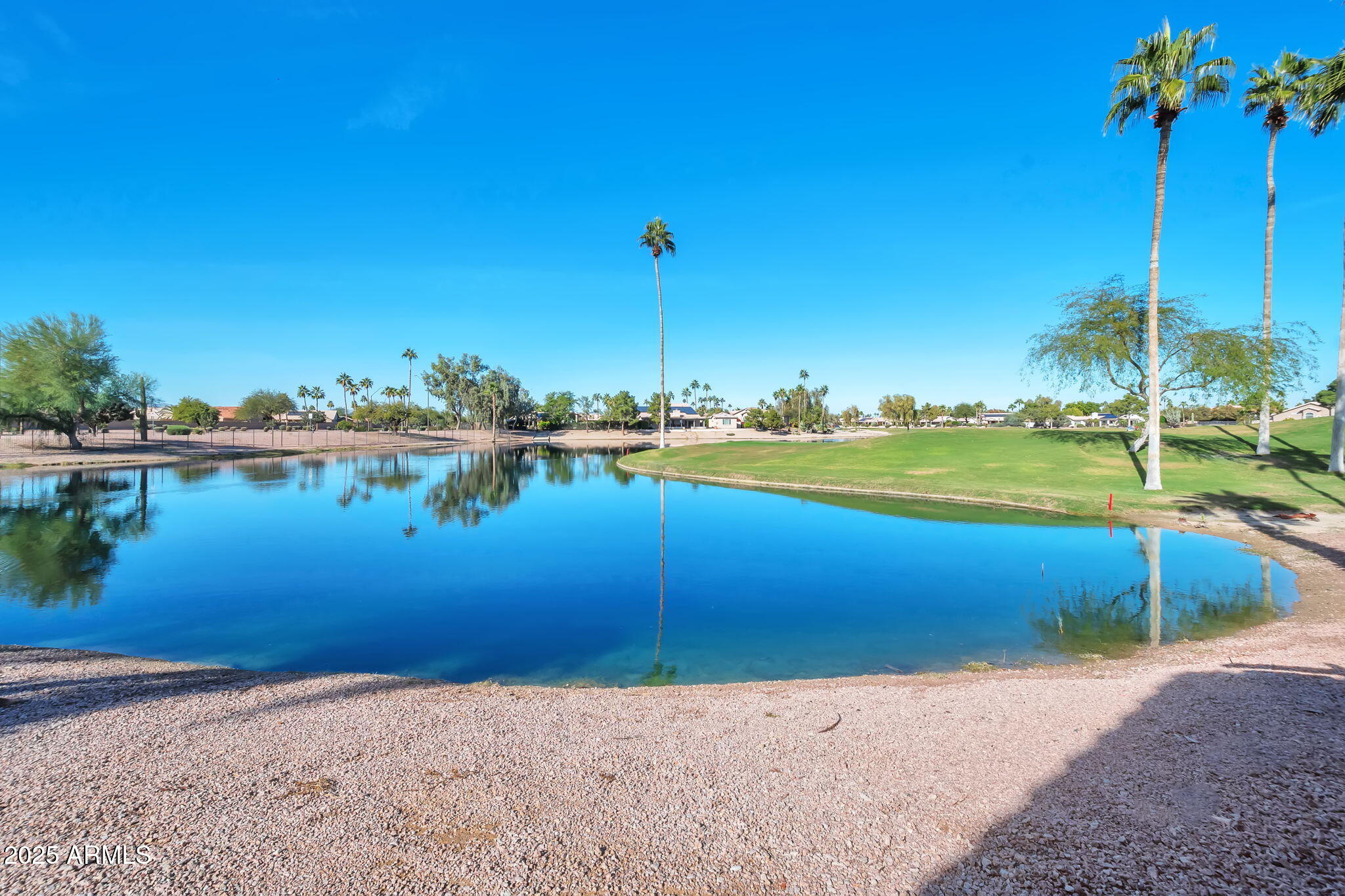 a view of a lake with houses in the back