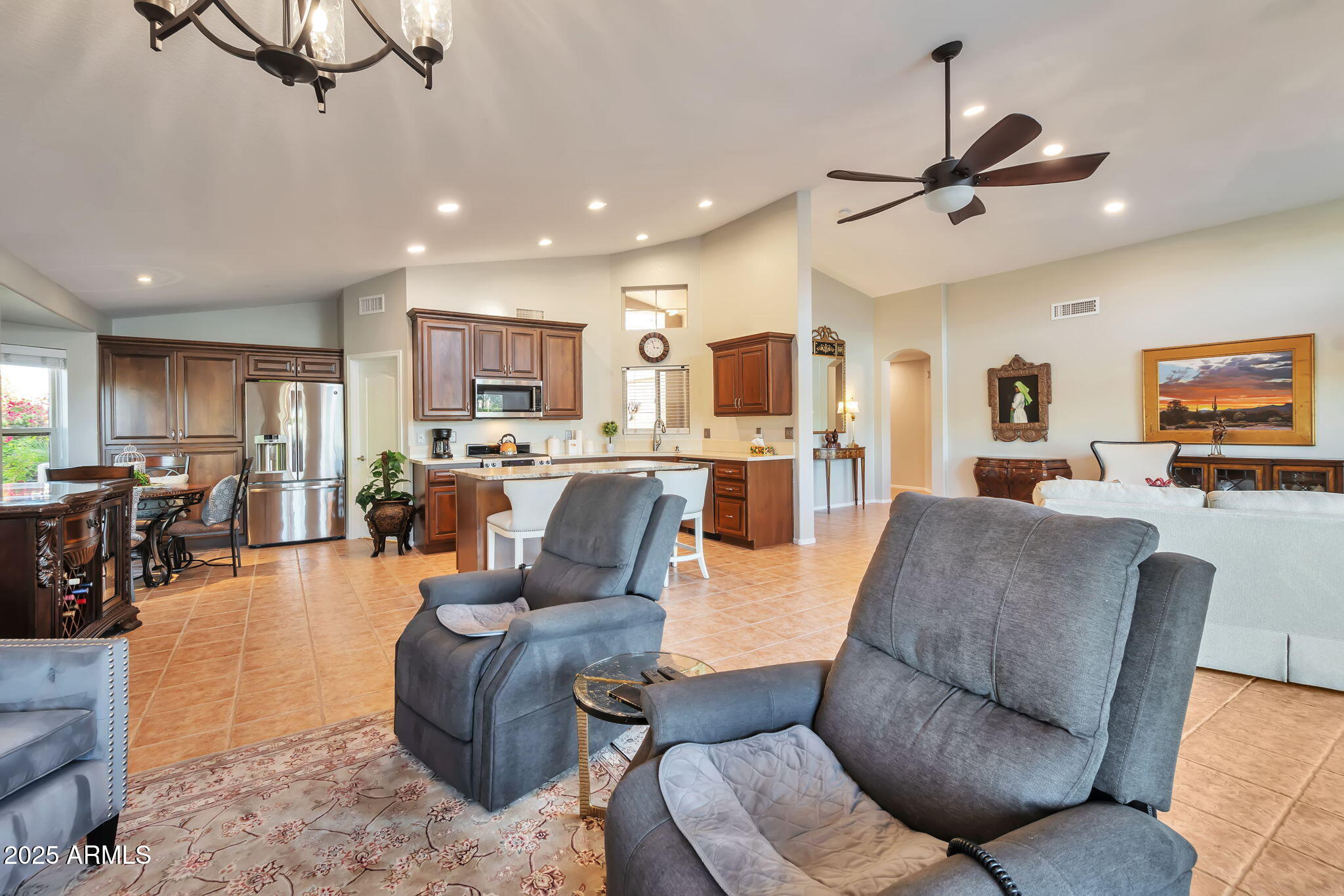 15460 West Merrell Street Goodyear, AZ 85395 - Photo 14 of 30 a living room with furniture kitchen view and a wooden floor
