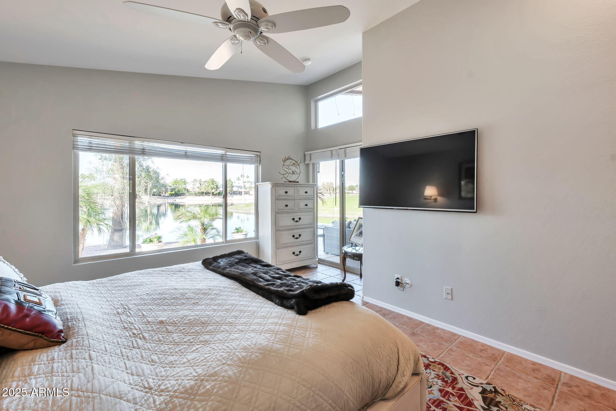 15460 West Merrell Street Goodyear, AZ 85395 - Photo 16 of 30 a bedroom with a bed and a flat screen tv