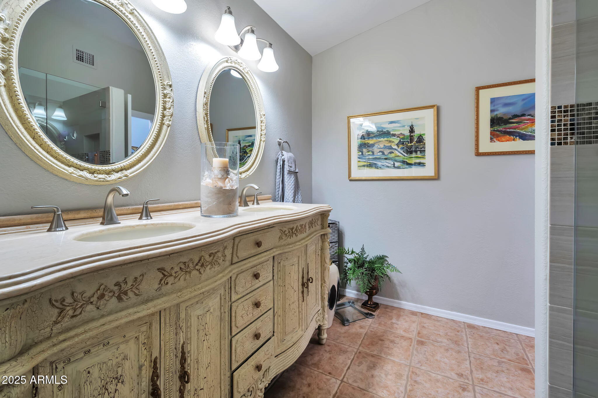 15460 West Merrell Street Goodyear, AZ 85395 - Photo 19 of 30 a bathroom with double vanity sinks and a mirror