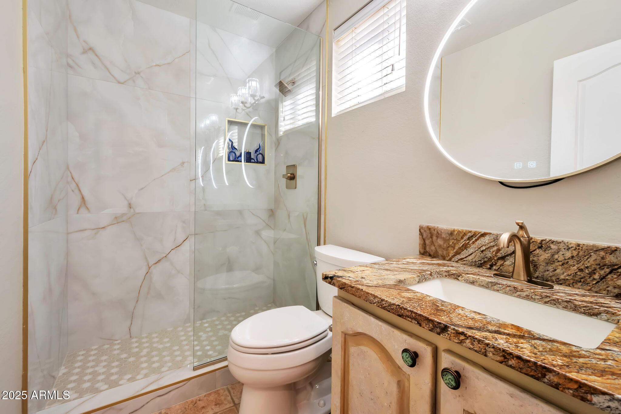 15460 West Merrell Street Goodyear, AZ 85395 - Photo 22 of 30 a bathroom with a sink a toilet and shower