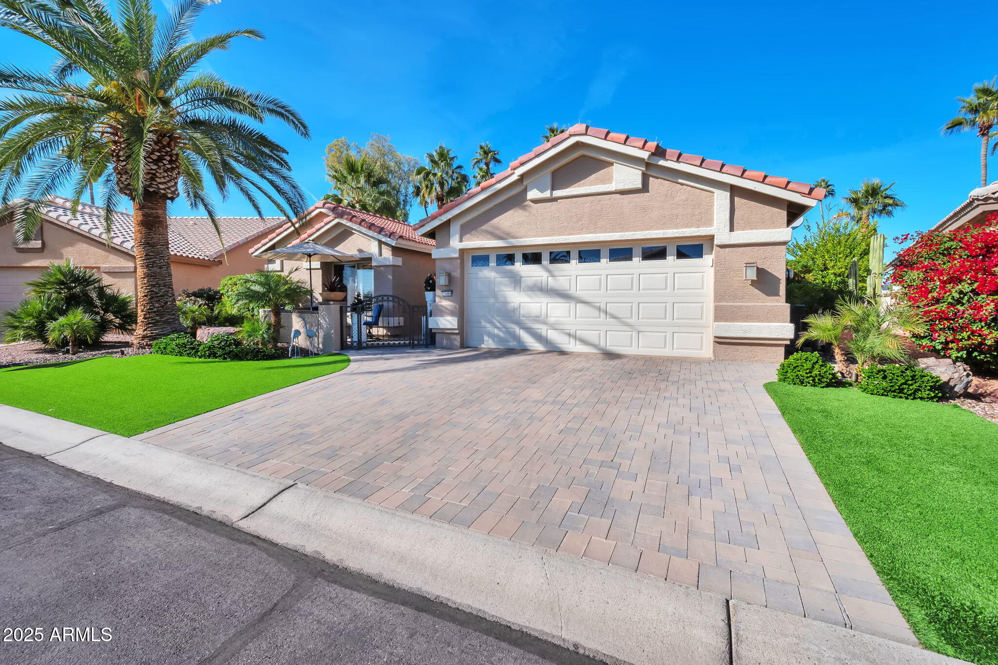 15460 West Merrell Street Goodyear, AZ 85395 - Photo 26 of 30 a front view of a house with a yard and potted plants